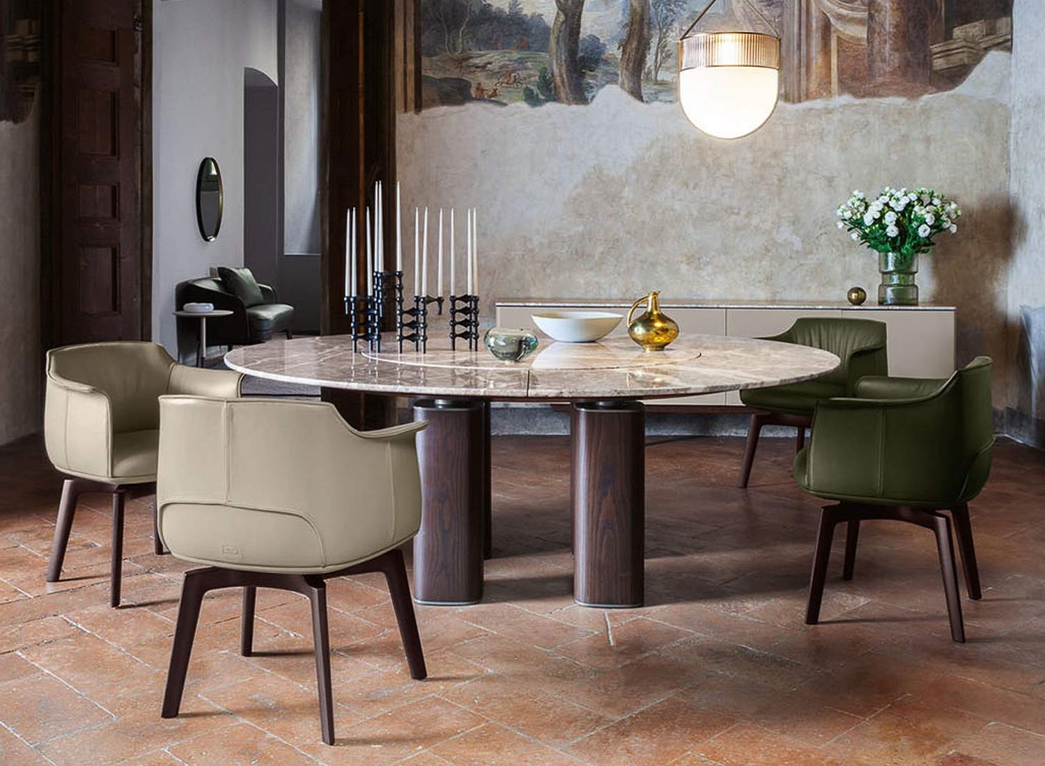 Poltrona Frau Archibald dining chairs around a round table, featured by Stanzo Italia.